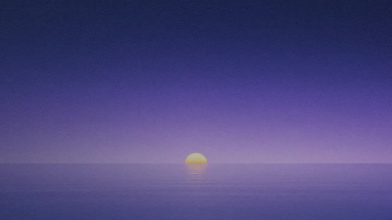 A half sun on a calm sea horizon under a navy-to-lavender sky